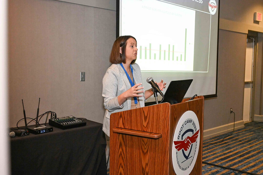 A woman discussing a partnership with IQNET Association.