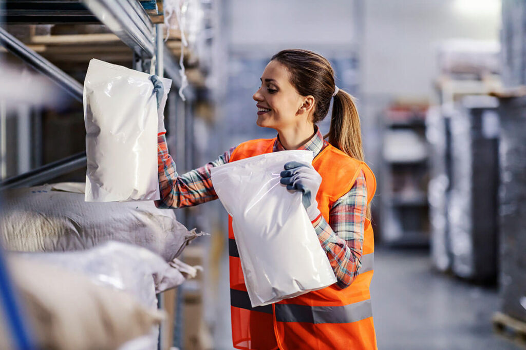 Woman holding a package in each hand.