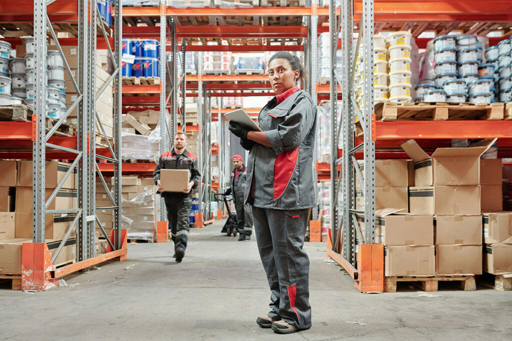 Woman holding a clipboard, inspecting inventory.
