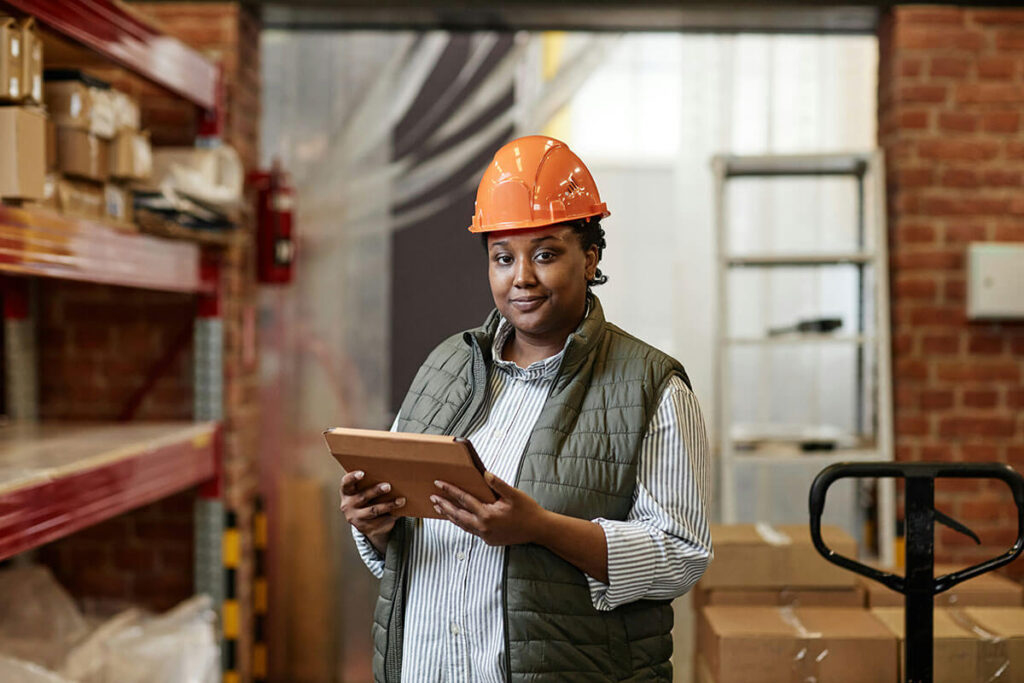 Woman smiling holding a tablet.